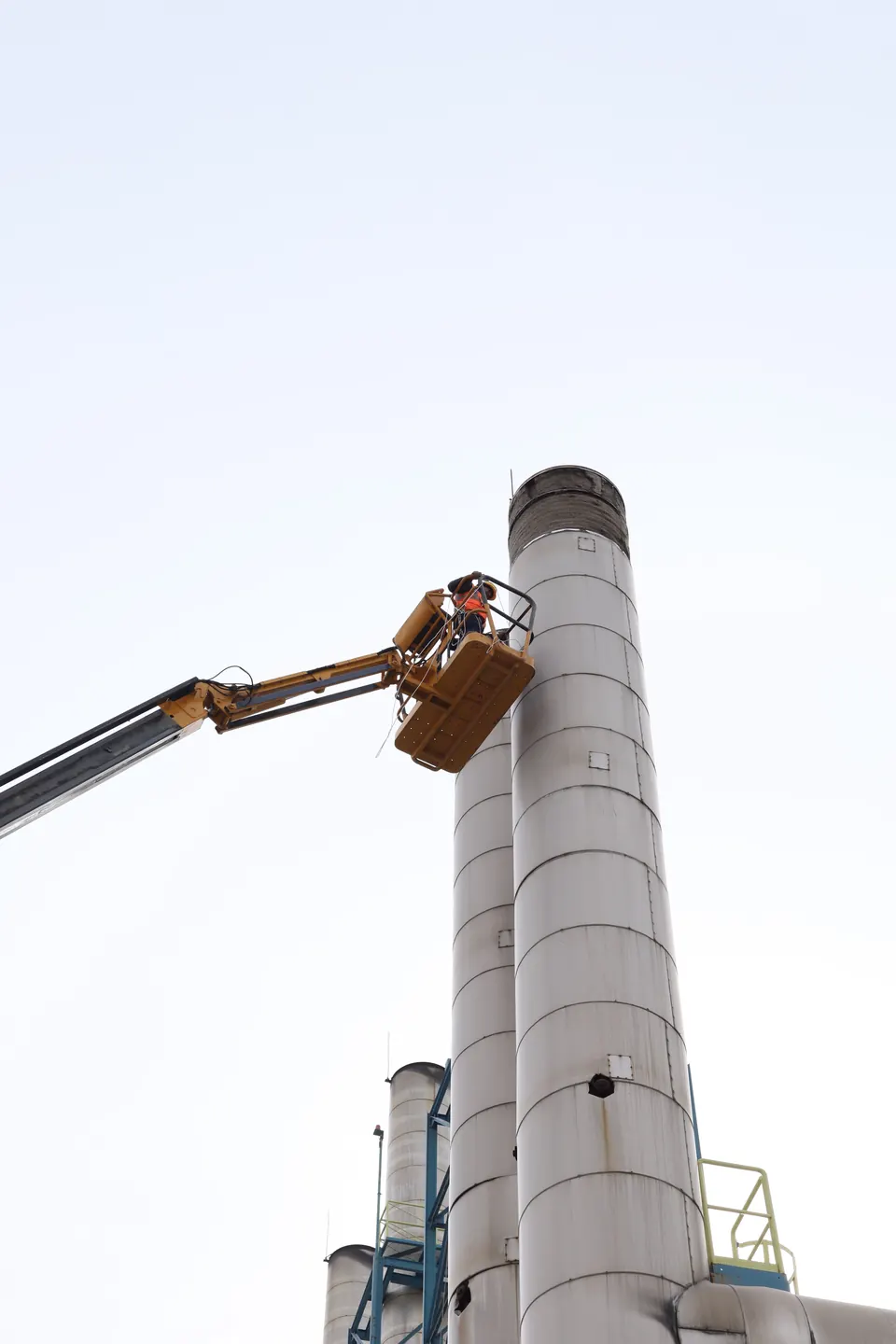A field worker beside infrastructure requiring an on-site inspection